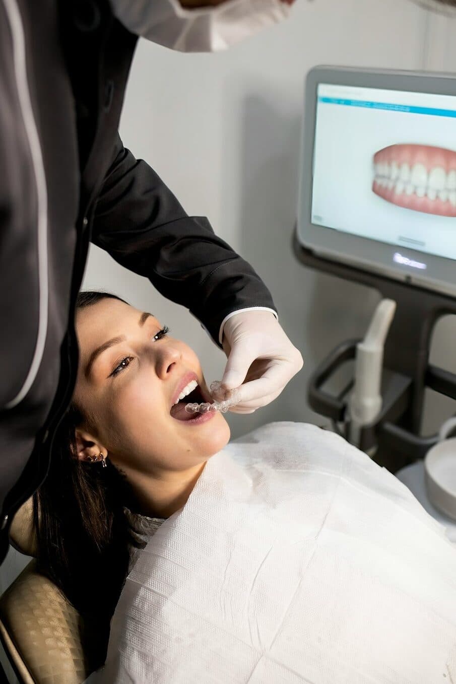 Patient being fitted with a clear aligner