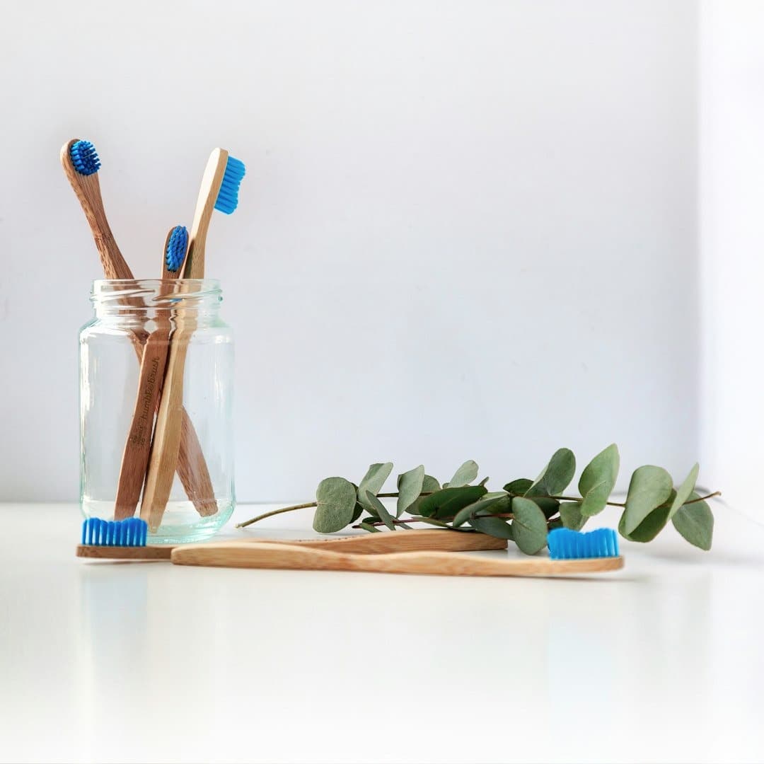 Bamboo toothbrushes in a glass jar